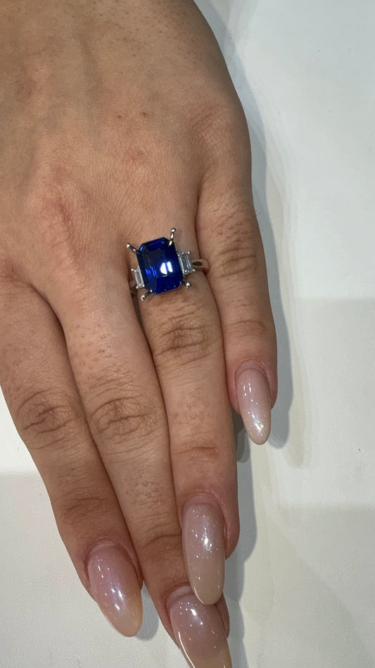 7 1/2 carat blue sapphire placed over a trapezoid 3 stone ring 