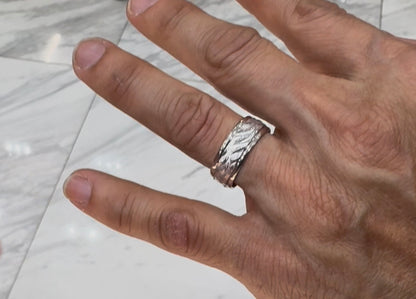 White gold men’s Wedding Band leaf design shown as worn on a men’s finger 
