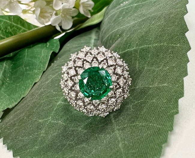 Inaya 1.77 Carats Round Cut Emerald Gemstone Ring in 18K White Gold with a background